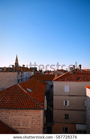 Red roofs of the city. Old Town under the bright sky. Ancient antique brickwork.