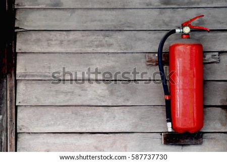 Old Fire extinguisher on wooden wall
