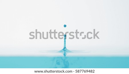 side view of bright blue water drop with accurate splash, 4k photo
