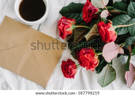 a bouquet of red roses coffee card with congratulations supply in bed