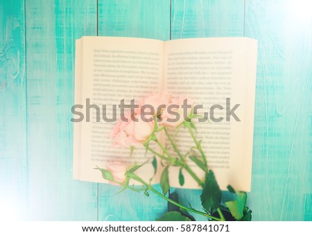 delicate pink flowers on the pages of the book, the concept of romance, space for text, soft