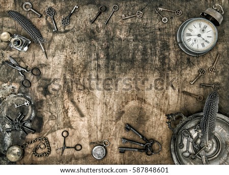 Wooden background with vintage office accessories. Antique scissors, keys, alarm clock, ink pen