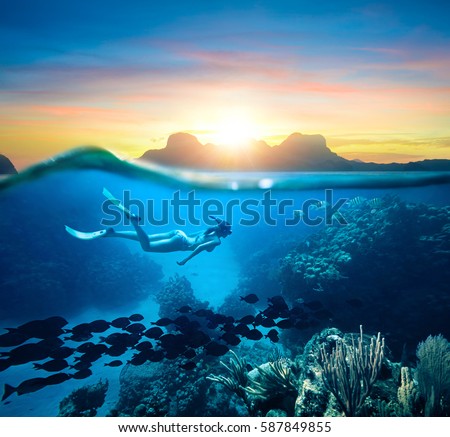 Young woman snorkeling near the coral reef in the tropical Caribian sea on sunset day.