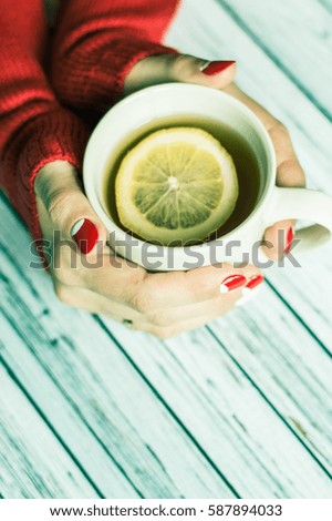 Woman holding a cup with tea