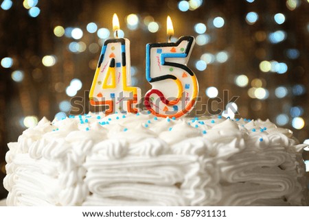 Birthday cake with candles on bokeh background