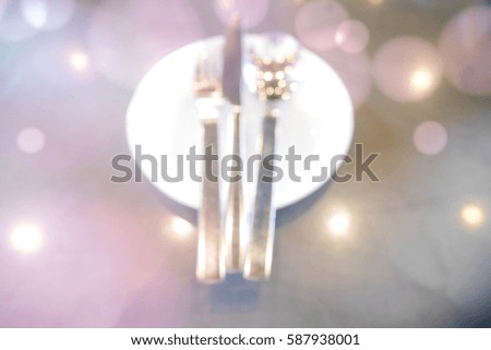 Picture blurred  for background abstract and can be illustration to article of white plate with silver fork knife and spoon