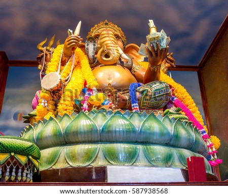 Colorful statue of the God Ganesha, interior of Hindu monastery. Richly decorated sculpture of God as the elephant. Symbol for eastern religions.