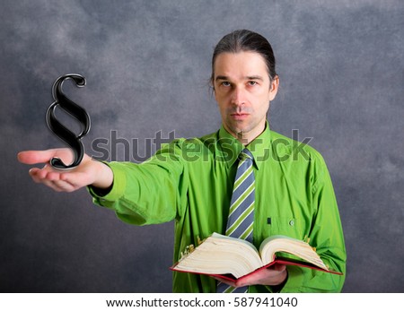 young lawyer in green shirt and necktie with statute book and paragraph