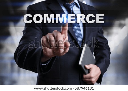 Businessman is pressing button on touch screen interface and selecting commerce.