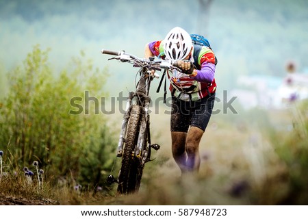 athlete cyclist mountainbiker going uphill with my bike Royalty-Free Stock Photo #587948723