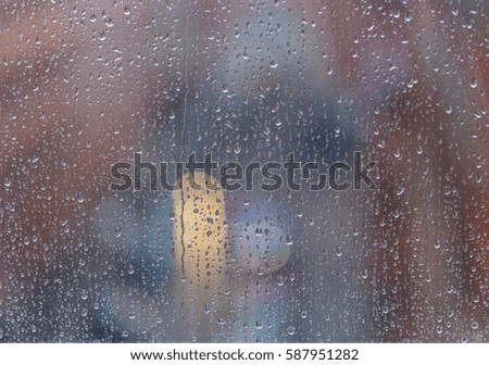rain drops on the window, rainy evening, traffic bokeh lights  