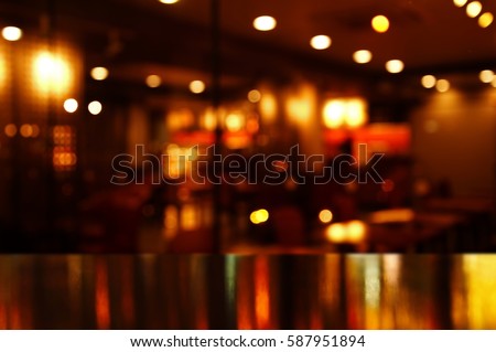reflection light on table in bar and pub at night background Royalty-Free Stock Photo #587951894