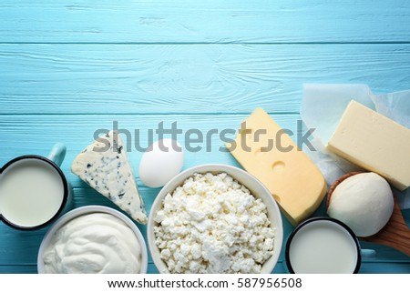 Fresh dairy products on blue wooden background Royalty-Free Stock Photo #587956508