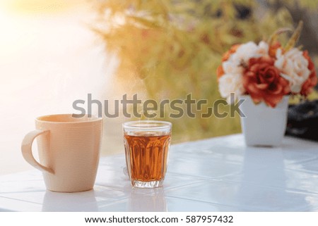 Hot tea cup and coffee on the table in morning.