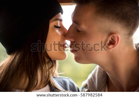 Kissing couple, close-up portrait of man and woman. Kiss, love and relationship of boy and girl Royalty-Free Stock Photo #587982584