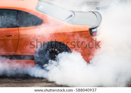 Rear wheel drive super sport car burning tire for warm up before competition to increase type temperature for good traction and grip. Royalty-Free Stock Photo #588040937