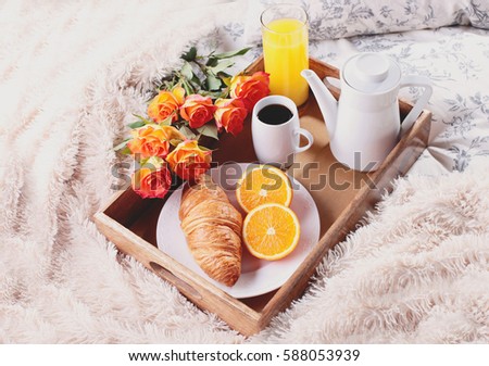 breakfast in bed with coffee croissant orange and juice