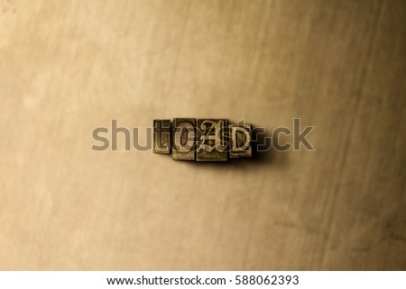 LOAD - close-up of grungy vintage typeset word on metal backdrop. Royalty free stock illustration.  Can be used for online banner ads and direct mail.