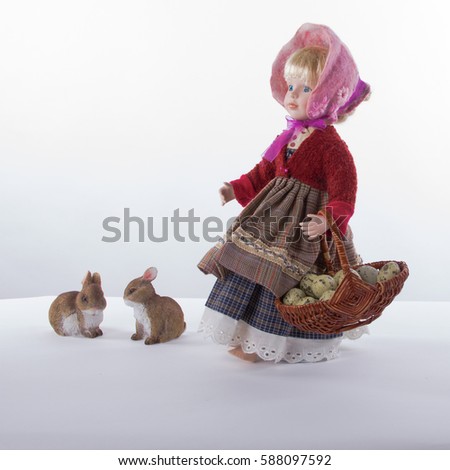 Easter scene. Girl-doll with festive clothing and bascet full of quail eggs walks from Easter market