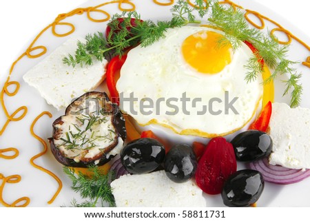 egg served on white plate with vegetables