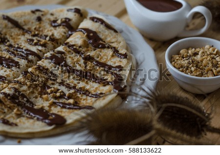 Pancakes with chocolate sauce and nuts for breakfast  