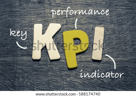 KPI (key performance indicator) on wood background Royalty-Free Stock Photo #588174740