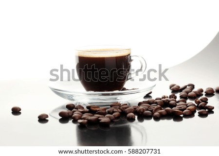 Coffee cup and coffee beans on table