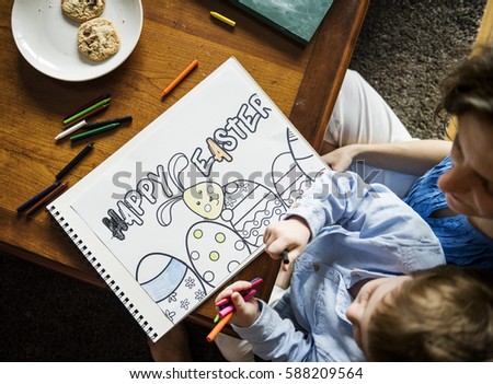 Little boy drawing a picture about easter