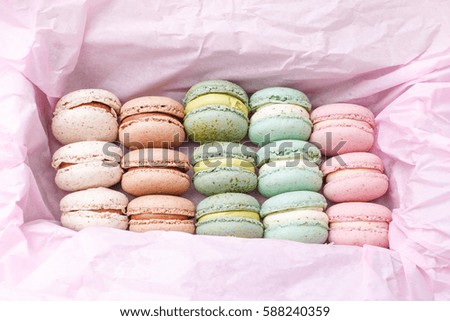 Macarons cake, sweet macaroon on top pink food background.