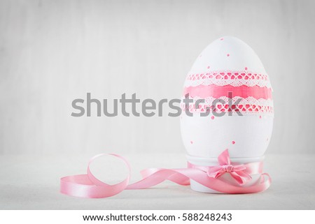 Single easter handmade egg on wooden white table. Decoupage art, pastel tone