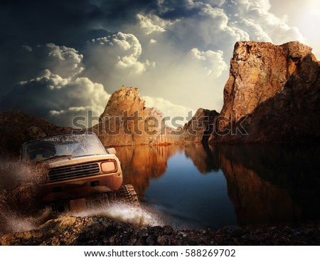 Four by four off road car crossing the lake  with splashing water, Travel and racing concept for four wheel drive off road vehicle . Royalty-Free Stock Photo #588269702