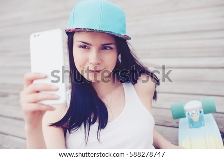 Pretty young girl taking selfie photo with new smart phone.Buy new mobile phone with good camera,take great pictures.Mobile photography is popular trend.Happy girl with dual camera smartphone in hand