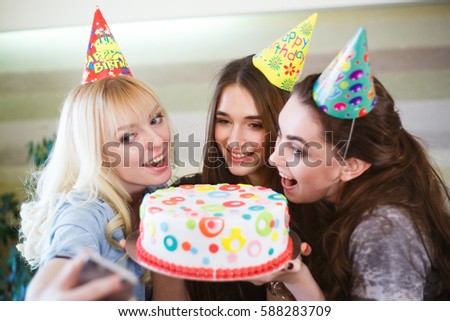Birthday. Girls bite cake at a birthday party.