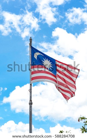 malaysian flag on a flag pole at blue sky background