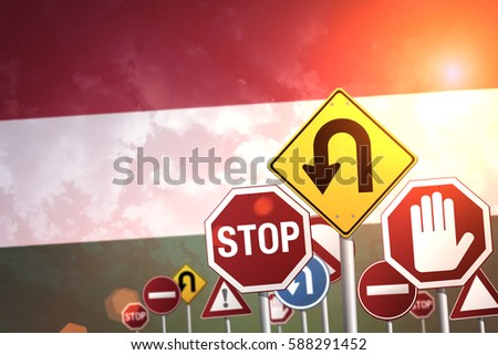 Road stop sign on a background of Hungary flag
