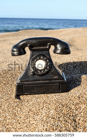 Photo Picture of an Old Phone on the Sand Beach
