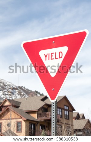Yield sign in town, in front of condos