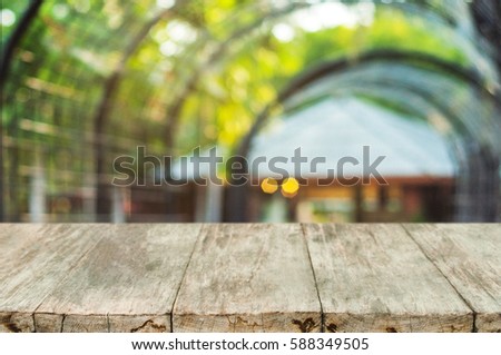 Selected focus empty wooden table and blurred Pergola with building background