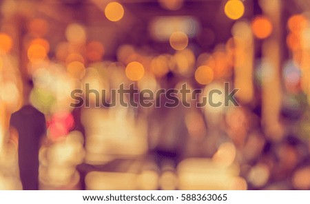 Image of blur people walking at corridor  with bokeh for background usage .(vintage tone)