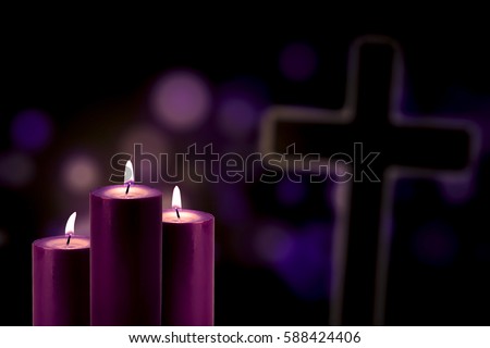 Lent season concept: Picture of three purple candles glowing with a cross symbol and bokeh background