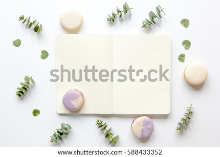 woman table with notebook, macaroons and eucalyptus top view mock-up