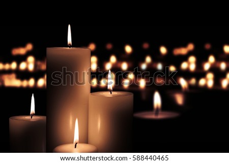 Picture of Easter candles burning at night with golden light of candle flame