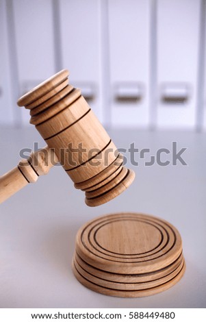 A wooden judge gavel and soundboard isolated on white background in perspective