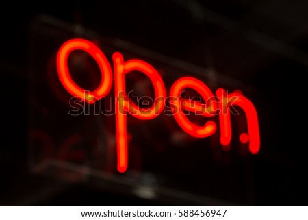 Red neon open sign for local business blurred 