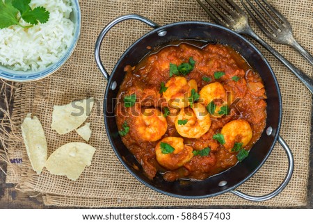 Prawn curry with rice and popodoms - top view Royalty-Free Stock Photo #588457403
