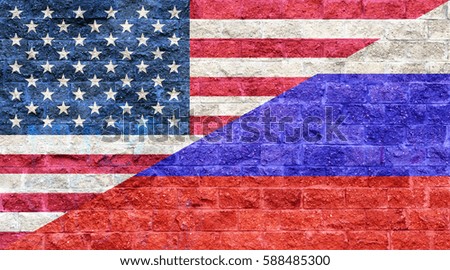 American flag and Russian flag painted on old brick wall