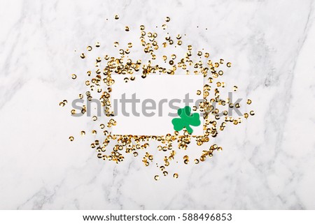 St.Patrick 's Day concept. Empty card with clover leafi and gold confetti frame. Mockup template. View from above