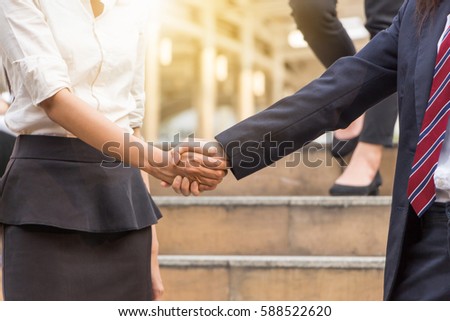 Success and Happiness Team Concept, Business woman handshake at city background.