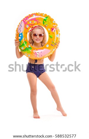 Isolated on white, pretty little caucasian blonde girl in red striped bikini, blue bottoms, sunglasses and pink flower wreath hold colorful rubber ring near her face
Vertical picture