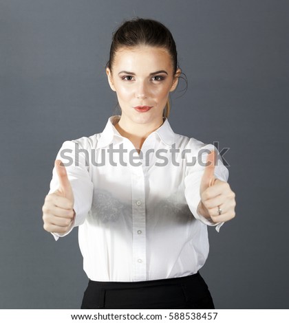

Beautiful  business woman holds  two  fingers up, international success symbol. 
